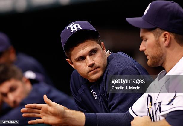 Catcher Kelly Shoppach of the Tampa Bay Rays talks with pitcher Wade Davis in the dugout during the game against the Kansas City Royals at Tropicana...