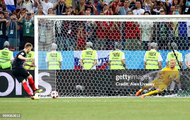 Ivan Rakitic of Croatia scores his team's fifthpenalty in the penalty shoot out past Kasper Schmeichel of Denmark during the 2018 FIFA World Cup...