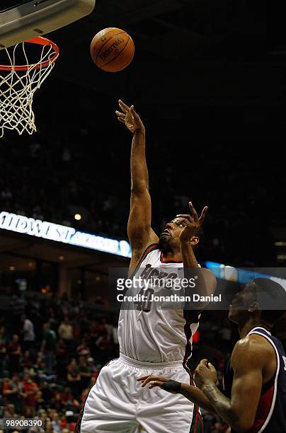 Kurt Thomas of the Milwaukee Bucks puts up a shot over Joe Johnson of the Atlanta Hawks in Game Six of the Eastern Conference Quarterfinals during...