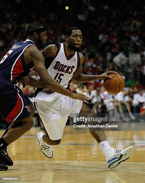 John Salmons of the Milwaukee Bucks drives around Mario West of the Atlanta Hawks in Game Six of the Eastern Conference Quarterfinals during the 2010...