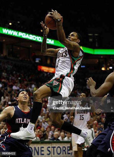 Brandon Jennings of the Milwaukee Bucks drives to the basket over Mike Bibby of the Atlanta Hawks in Game Six of the Eastern Conference Quarterfinals...