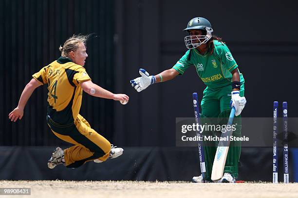 Clea Smith of Australia tumbles to the ground as Trisha Chetty of South Africa puts out a helping hand during the ICC T20 Women's World Cup Group A...