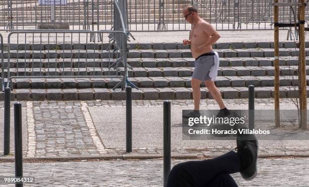 Jogger runs by Altice Arena in Parque das Nacoes during a sunny Sunday morning on July 01, 2018 in Lisbon, Portugal. Sunny weather is one of the...