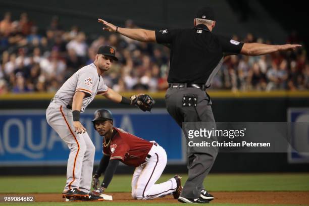 Infielder Joe Panik of the San Francisco Giants reacts after Jarrod Dyson of the Arizona Diamondbacks safely stool second base during the first...