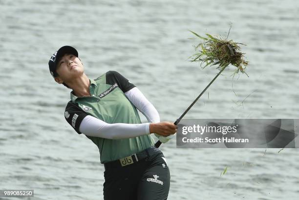 Sung Hyun Park of South Korea plays a shot from the water's edge on the 16th hole during the final round of the KPMG Women's PGA Championship at...