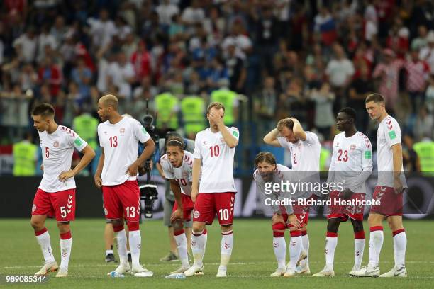 Denmark players look dejected following their sides defeat in the 2018 FIFA World Cup Russia Round of 16 match between Croatia and Denmark at Nizhny...