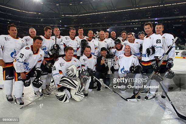 Wladimir KLitschko poses with the trophee and the team of legends ahead of the IIHF World Championship group D match between USA and Germany at...