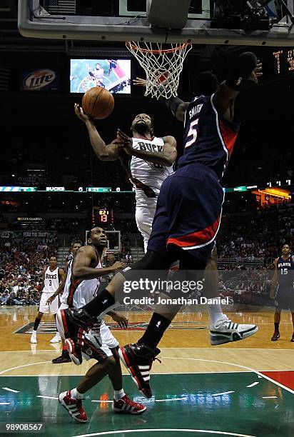 John Salmons of the Milwaukee Bucks puts up a shot against Josh Smith of the Atlanta Hawks in Game Six of the Eastern Conference Quarterfinals during...