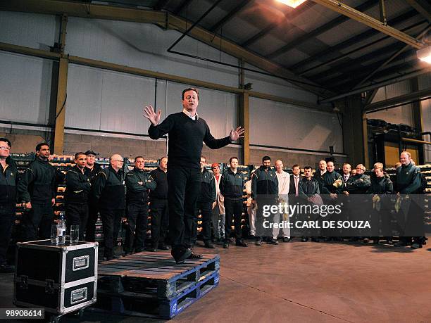 Britain's Conservative Party leader David Cameron talks to staff at supermarket chain Morrisons' distribution centre in Wakefield, West Yorkshire, on...