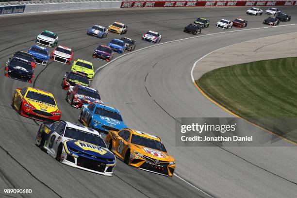 Chase Elliott, driver of the NAPA Auto Parts Chevrolet, and Erik Jones, driver of the DeWalt Toyota, lead a pack of cars during the Monster Energy...