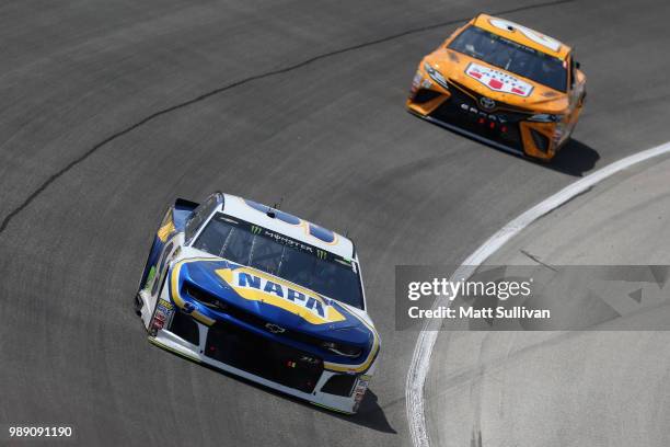 Chase Elliott, driver of the NAPA Auto Parts Chevrolet, leads Erik Jones, driver of the DeWalt Toyota, during the Monster Energy NASCAR Cup Series...