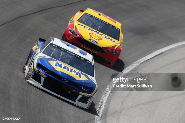 Chase Elliott, driver of the NAPA Auto Parts Chevrolet, leads Joey Logano, driver of the Shell Pennzoil Ford, during the Monster Energy NASCAR Cup...