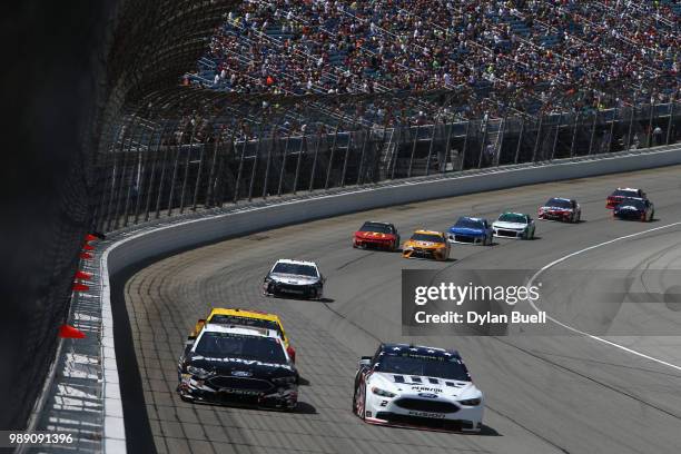 Aric Almirola, driver of the Smithfield Ford, and Brad Keselowski, driver of the Stars Stripes and Lites Ford, lead a pack of cars during the Monster...