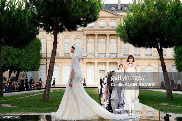 Models present creations by Givenchy at the end of the 2018-2019 Fall/Winter Haute Couture collection fashion show in Paris, on July 1, 2018.