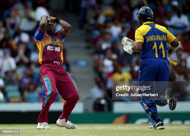 Dwayne Bravo of The West Indies looks despondent as Kumar Sangakkara scores runs during The ICC World Twenty20 Super Eight Match between The West...