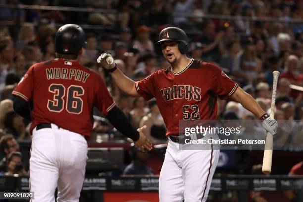 Zack Godley of the Arizona Diamondbacks high fives John Ryan Murphy after scoring against the San Francisco Giants during the second inning of the...