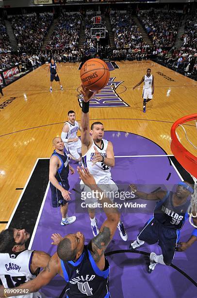 Francisco Garcia of the Sacramento Kings shoots a layup over Caron Butler and Jason Terry of the Dallas Mavericks during the game at Arco Arena on...