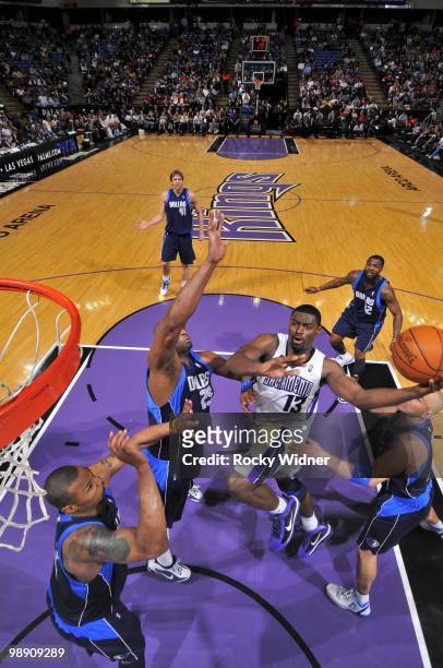 Tyreke Evans of the Sacramento Kings drives to the basket for a layup against Erick Dampier, Jason Kidd and Caron Butler of the Dallas Mavericks...
