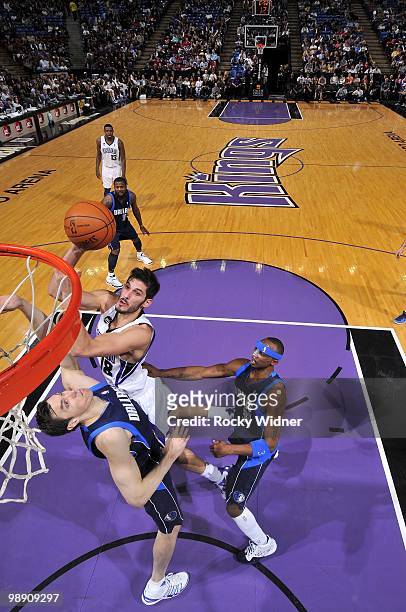 Omri Casspi of the Sacramento Kings goes up for a shot against Eduardo Najera and Jason Terry of the Dallas Mavericks during the game at Arco Arena...