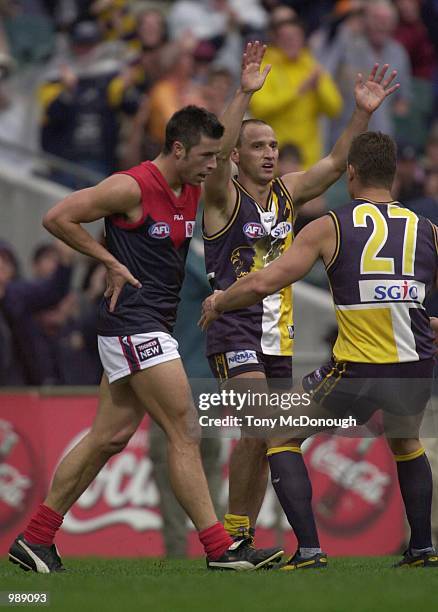 Andrew Leoncelli of Melbourne walks past Glen Jakovich and Phillip Matera of West Coast Eagles during round 13 AFL match between the West Coast...