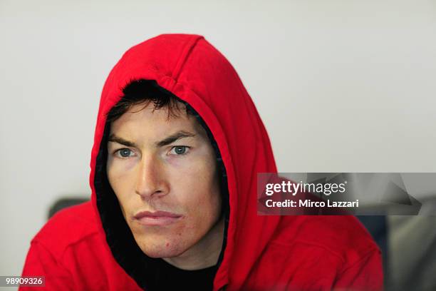 Nicky Hayden of USA looks on in box of his brother Roger Lee Hayden of USA and Team Pedercini during the the first qualifying practice of the...