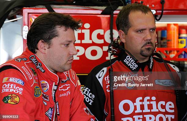 Tony Stewart , driver of the Old Spice/Office Depot Chevrolet looks on with crew chief Darian Grubb , during practice for the NASCAR Sprint Cup...