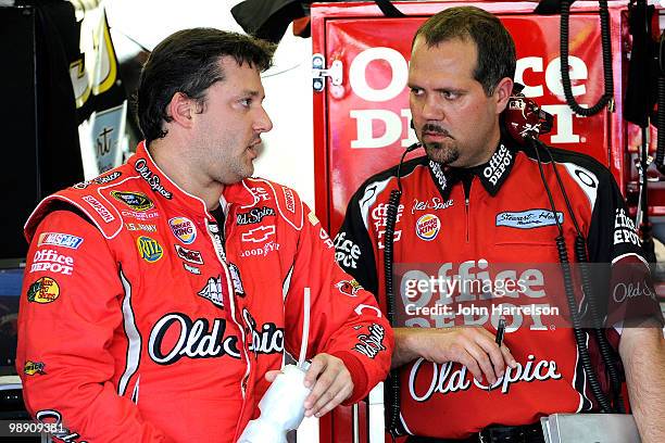 Tony Stewart , driver of the Old Spice/Office Depot Chevrolet speaks with crew chief Darian Grubb , during practice for the NASCAR Sprint Cup Series...