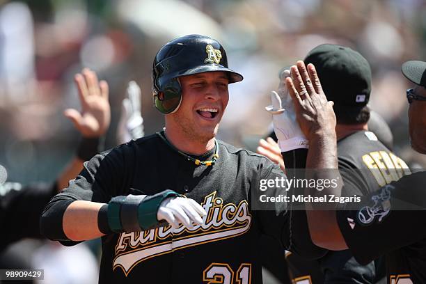 Ryan Sweeney of the Oakland Athletics being congratulated by the dugout during the game against the Cleveland Indians at the Oakland Coliseum on...