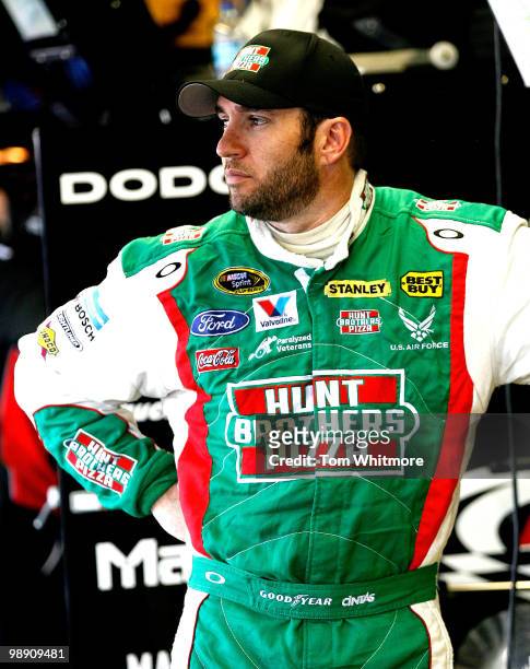 Elliott Sadler, driver of the Hunt Brothers Pizza Ford, stands in the garage during practice for the NASCAR Sprint Cup Series SHOWTIME Southern 500...