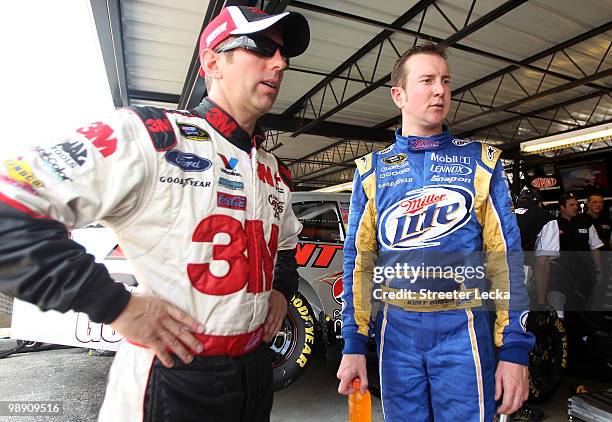 Greg Biffle , driver of the 3M Ford, talks to Kurt Busch, driver of the Miller Lite Dodge, during practice for the NASCAR Sprint Cup Series SHOWTIME...