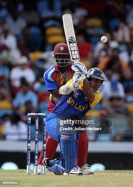 Andre Fletcher of The West Indies looks on as Kumar Sangakkara hits out during The ICC World Twenty20 Super Eight Match between The West Indies and...