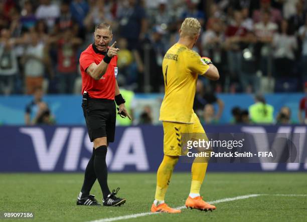 Kasper Schmeichel of Denmark and match referee Nestor Pitana speak inbetween penalties during the 2018 FIFA World Cup Russia Round of 16 match...