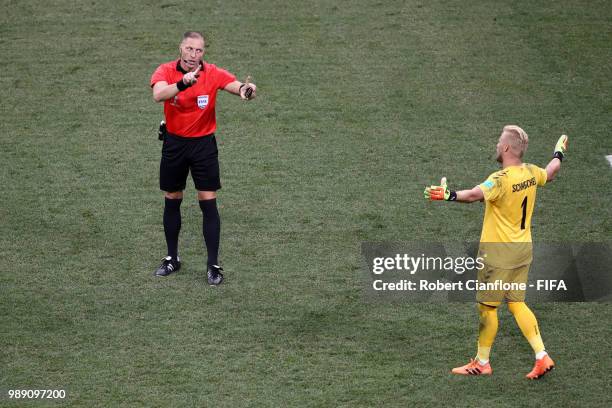 Kasper Schmeichel of Denmark and match referee Nestor Pitana speak inbetween penalties during the 2018 FIFA World Cup Russia Round of 16 match...