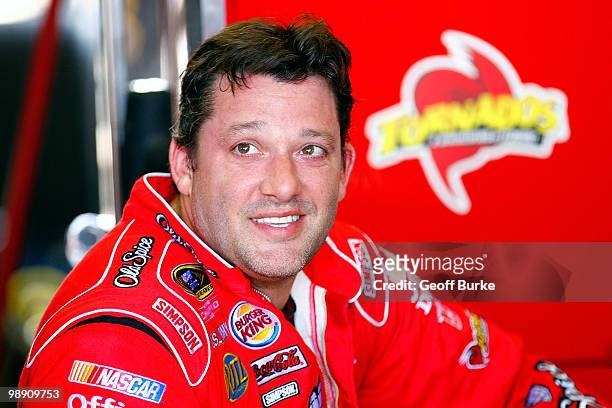 Tony Stewart, driver of the Old Spice/Office Depot Chevrolet, sits in the garage during practice for the NASCAR Sprint Cup Series SHOWTIME Southern...