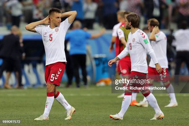 Jonas Knudsen of Denmark and Lasse Schone of Denmark look dejected following their sides defeat in the 2018 FIFA World Cup Russia Round of 16 match...