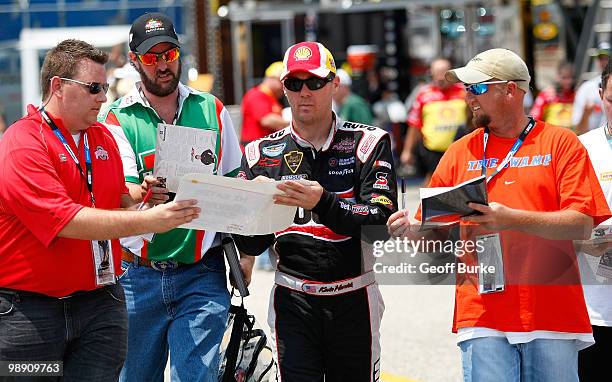 Kevin Harvick, driver of the Shell/Pennzoil Chevrolet, signs autographs in the garage during practice for the NASCAR Sprint Cup Series SHOWTIME...