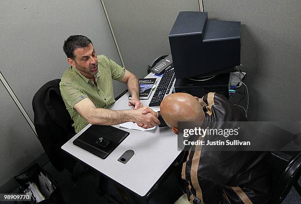 Vince Fortunato shakes hands with a job applicant during a job interview at the Career Link Center One Stop job center May 7, 2010 in San Francisco,...