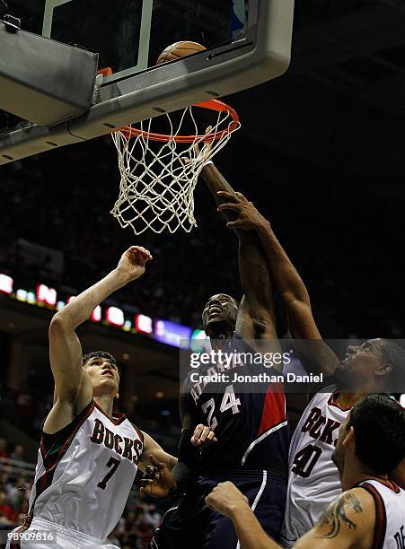 Marvin Williams of the Atlanta Hawks shoots over Ersan Ilyasova and Kurt Thomas of the Milwaukee Bucks in Game Six of the Eastern Conference...