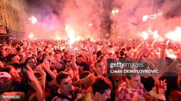 Croatia's supporters celebrate their team's victory against Denmark on the main square in the Croatian capital Zagreb, at the end of the 2018 FIFA...