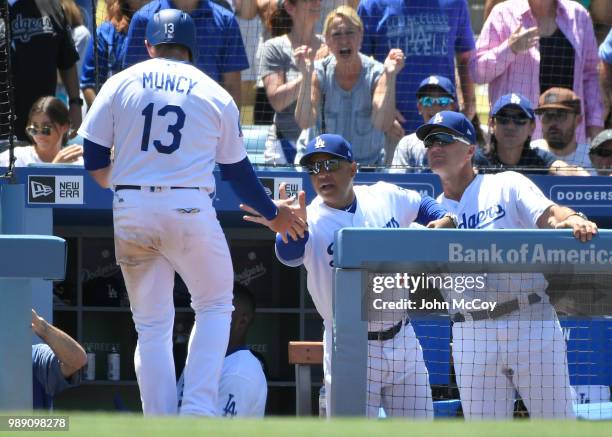 Max Muncy of the Los Angeles Dodgers is congratulated by Manager Dave Roberts and Bob Geren after scoring a run in the third inning agains tthe...