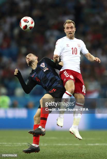 Mateo Kovacic of Croatia and Christian Eriksen of Denmark battle for the header during the 2018 FIFA World Cup Russia Round of 16 match between...