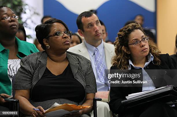 Job seekers look on as potential employers speak during a hiring event at the Career Link Center One Stop job center May 7, 2010 in San Francisco,...