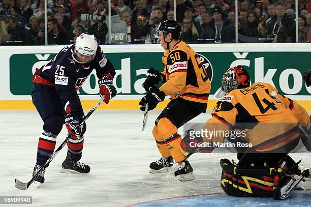 Dennis Endras , goalkeepr of Germany saves the shot of David Moss of USA during the IIHF World Championship group D match between USA and Germany at...