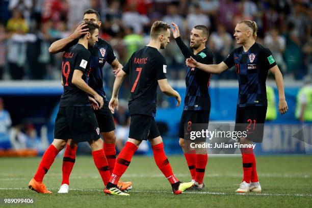 Croatia players console their team mate Milan Badelj following him missing his side's fourth penalty in the penalty shoot out during the 2018 FIFA...