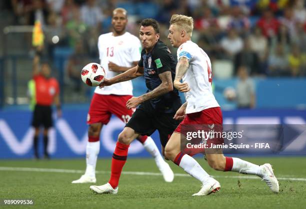 Mario Mandzukic of Croatia is challenged by Simon Kjaer of Denmark during the 2018 FIFA World Cup Russia Round of 16 match between Croatia and...