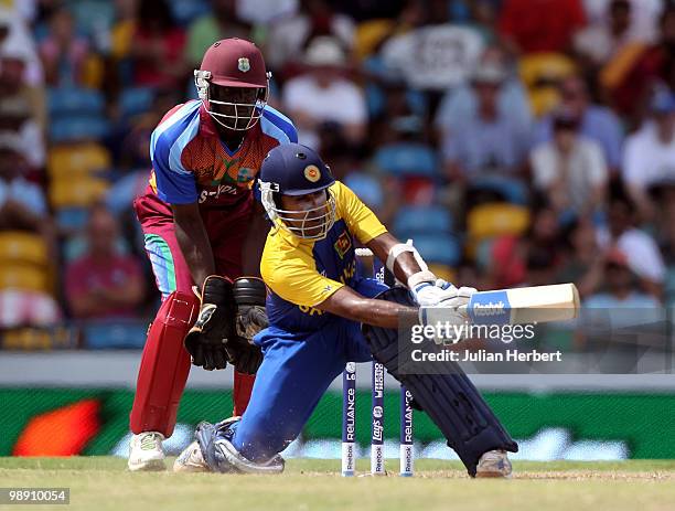 Andre Fletcher of The West Indies looks on as Mahela Jayawardene hits out during The ICC World Twenty20 Super Eight Match between The West Indies and...