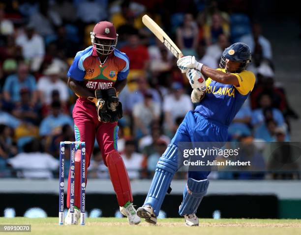 Andre Fletcher of The West Indies looks on as Kumar Sangakkara hits out during The ICC World Twenty20 Super Eight Match between The West Indies and...