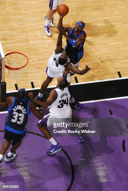 Jason Terry of the Dallas Mavericks goes up for a shot against Tyreke Evans and Jason Thompson of the Sacramento Kings during the game at Arco Arena...