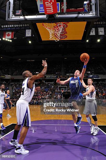 Jose Barea of the Dallas Mavericks shoots a layup against Carl Landry and Beno Udrih of the Sacramento Kings during the game at Arco Arena on April...