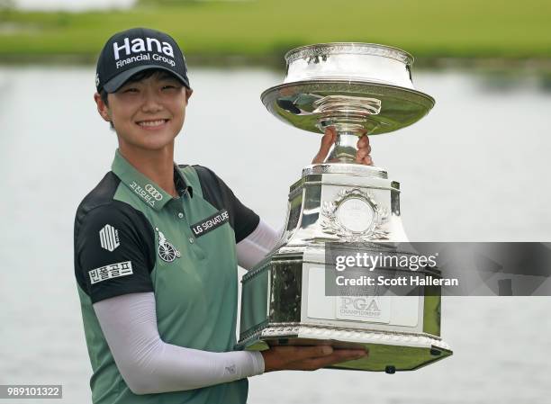 Sung Hyun Park of South Korea celebrates with the trophy after winning the KPMG Women's PGA Championship at Kemper Lakes Golf Club on July 1, 2018 in...